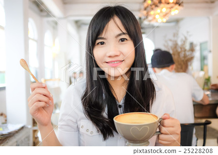 Asian young woman hold coffee cup 25228208