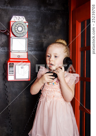Little girl with handset in hand 25239708