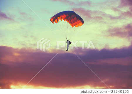 Skydiver On Colorful Parachute In Sunny Sky 25240195