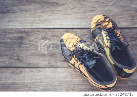 Old football shoes on grey wooden plank Old football shoes on grey wooden plank 25248713