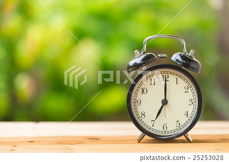 retro clock in green garden at 7 o'clock 25253028
