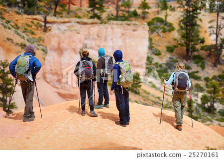 Group of hikers admiring view of sandstone hoodoos Group of hikers admiring view of sandstone hoodoos 25270161