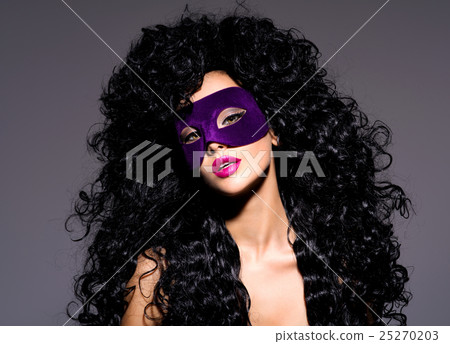 Beautiful woman with  violet theatre mask on face 25270203