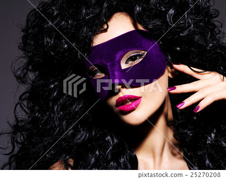 Beautiful woman with  violet theatre mask on face 25270208