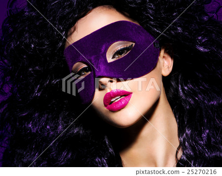 Beautiful woman with  violet theatre mask on face 25270216