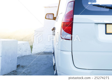 Rear view of car back parked on road during sunset Rear view of car back parked on road during sunset 25274271