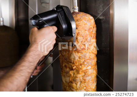 Closeup on cutting meat for kebab with special knife Closeup on cutting meat for kebab with special knife 25274723