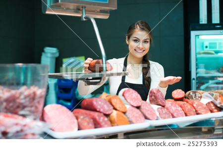 Female seller offering wursts Female seller offering wursts 25275393