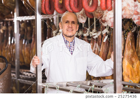 technologist posing with wurst and jamon 25275436