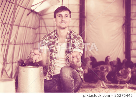 Young man farmer holding fresh eggs Young man farmer holding fresh eggs 25275445