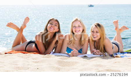 Girls in swimwear lying together 25276194