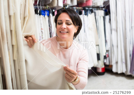Customer posing near cloth rolls Customer posing near cloth rolls 25276299