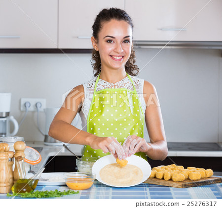 housewife cooking breadcrumbed croquettes housewife cooking breadcrumbed croquettes 25276317