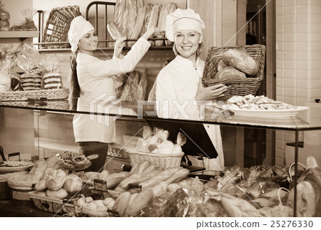 Portrait of friendly cheerful women at bakery display Portrait of friendly cheerful women at bakery display 25276330