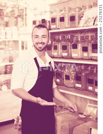 Cheerful seller in store of ecological goods. Cheerful seller in store of ecological goods. 25276331