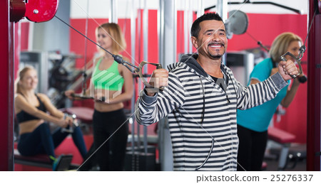 Active positive people weightlifting training in health club Active positive people weightlifting training in health club 25276337