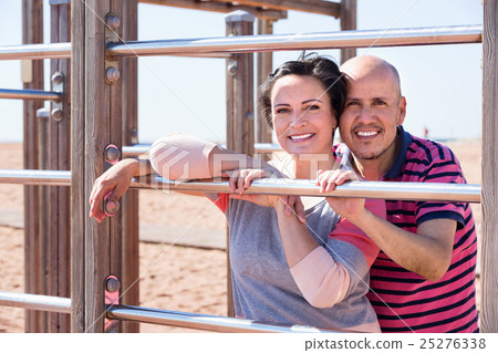 Portrait of charming couple embracing outdoors Portrait of charming couple embracing outdoors 25276338