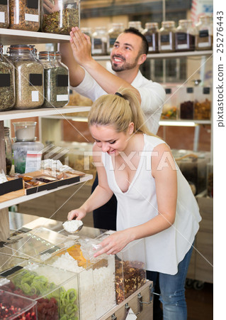 Young couple standing with dried berries sold Young couple standing with dried berries sold 25276443