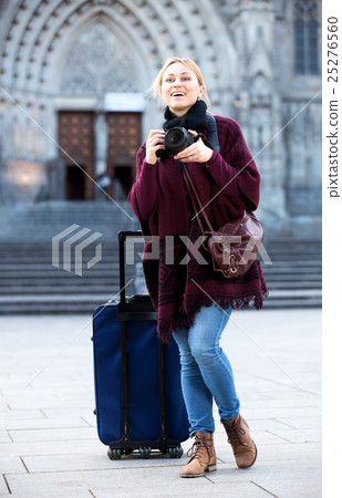 Girl holding camera in hands and photographing Girl holding camera in hands and photographing 25276560