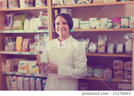 mature woman seller in drugstore . 25276643