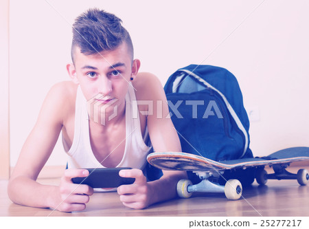 Teenager burying in mobile phone Teenager burying in mobile phone 25277217