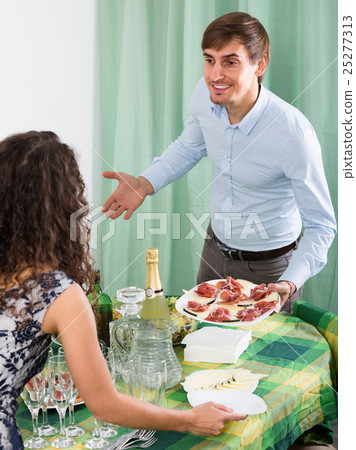 Young couple serving table at home . 25277313