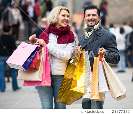 Mature couple in shopping tour. Mature couple in shopping tour. 25277323