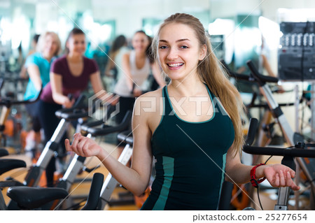 Females cycling in sport club . 25277654