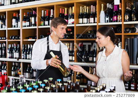 Seller helping to buy bottle 25277809