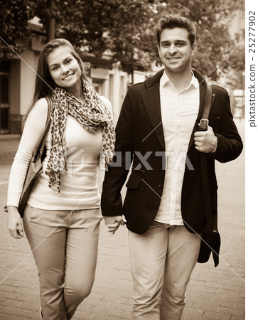 Happy young couple walking at autumn day Happy young couple walking at autumn day 25277902
