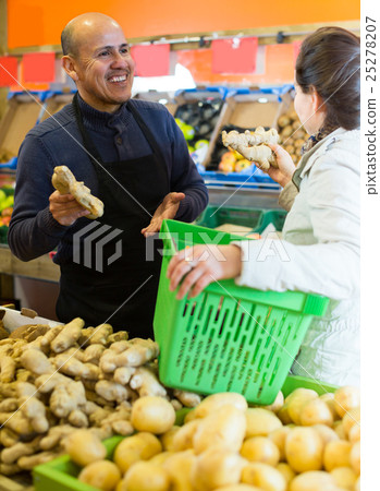 man helping customer to choose ginger man helping customer to choose ginger 25278207
