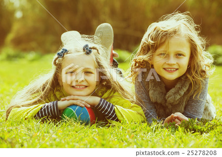 Portrait of two cute girls with ball Portrait of two cute girls with ball 25278208