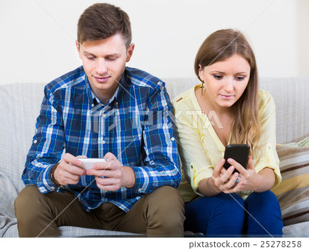 couple addicted to social networking with cell phones couple addicted to social networking with cell phones 25278258