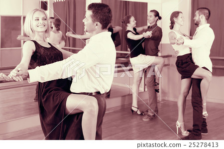 Three happy couples dancing tango 25278413