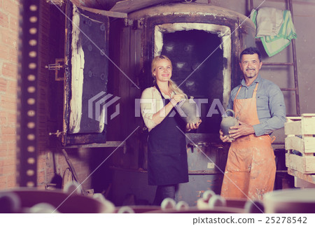 Two potters working in workshop. Two potters working in workshop. 25278542