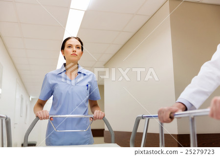 medic carrying hospital gurney at emergency 25279723