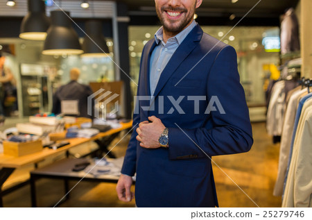 close up of happy man in suit at clothing store close up of happy man in suit at clothing store 25279746