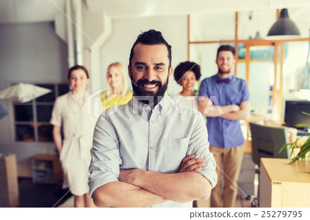 happy young man over creative team in office happy young man over creative team in office 25279795