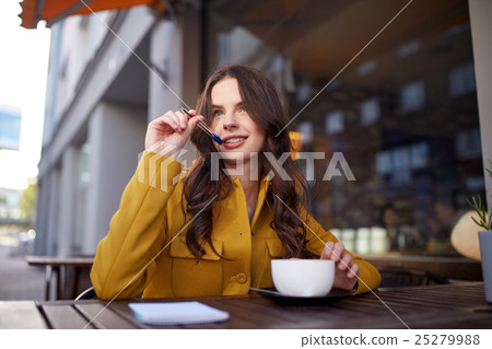happy woman with notebook drinking cocoa at cafe happy woman with notebook drinking cocoa at cafe 25279988