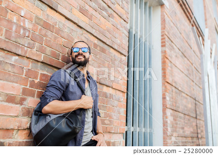 happy man with backpack standing at city street happy man with backpack standing at city street 25280000