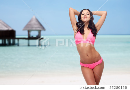 happy young woman in pink bikini swimsuit 25280136