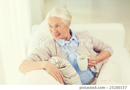 happy senior woman with cup of tea at home happy senior woman with cup of tea at home 25280157