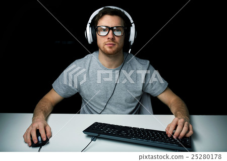 man in headset playing computer video game man in headset playing computer video game 25280178