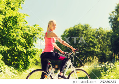 happy young woman riding bicycle outdoors happy young woman riding bicycle outdoors 25280283