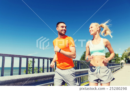smiling couple running at summer seaside smiling couple running at summer seaside 25280298