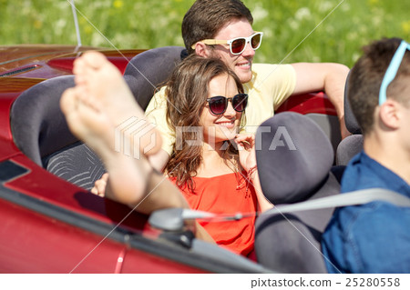 happy friends driving in cabriolet car outdoors 25280558