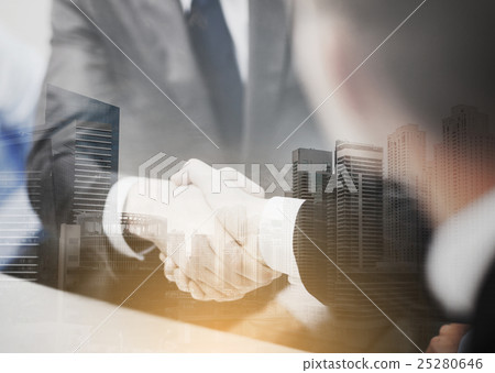 two businessmen shaking hands in office 25280646