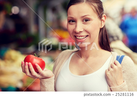happy woman holding tomato at street market happy woman holding tomato at street market 25281116