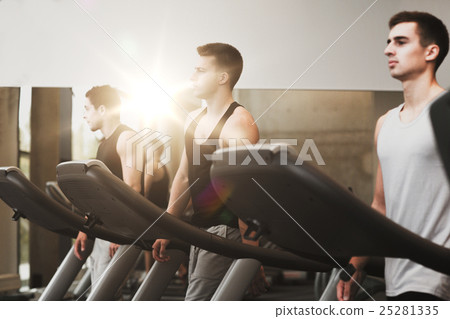 group of men exercising on treadmill in gym 25281335