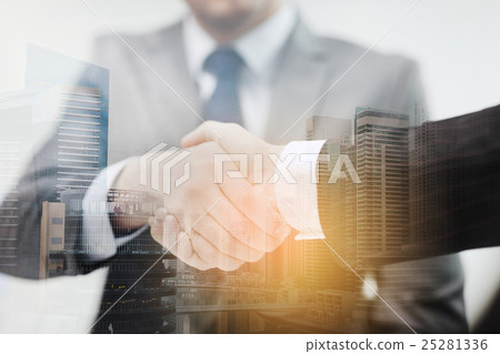 two businessmen shaking hands in office two businessmen shaking hands in office 25281336